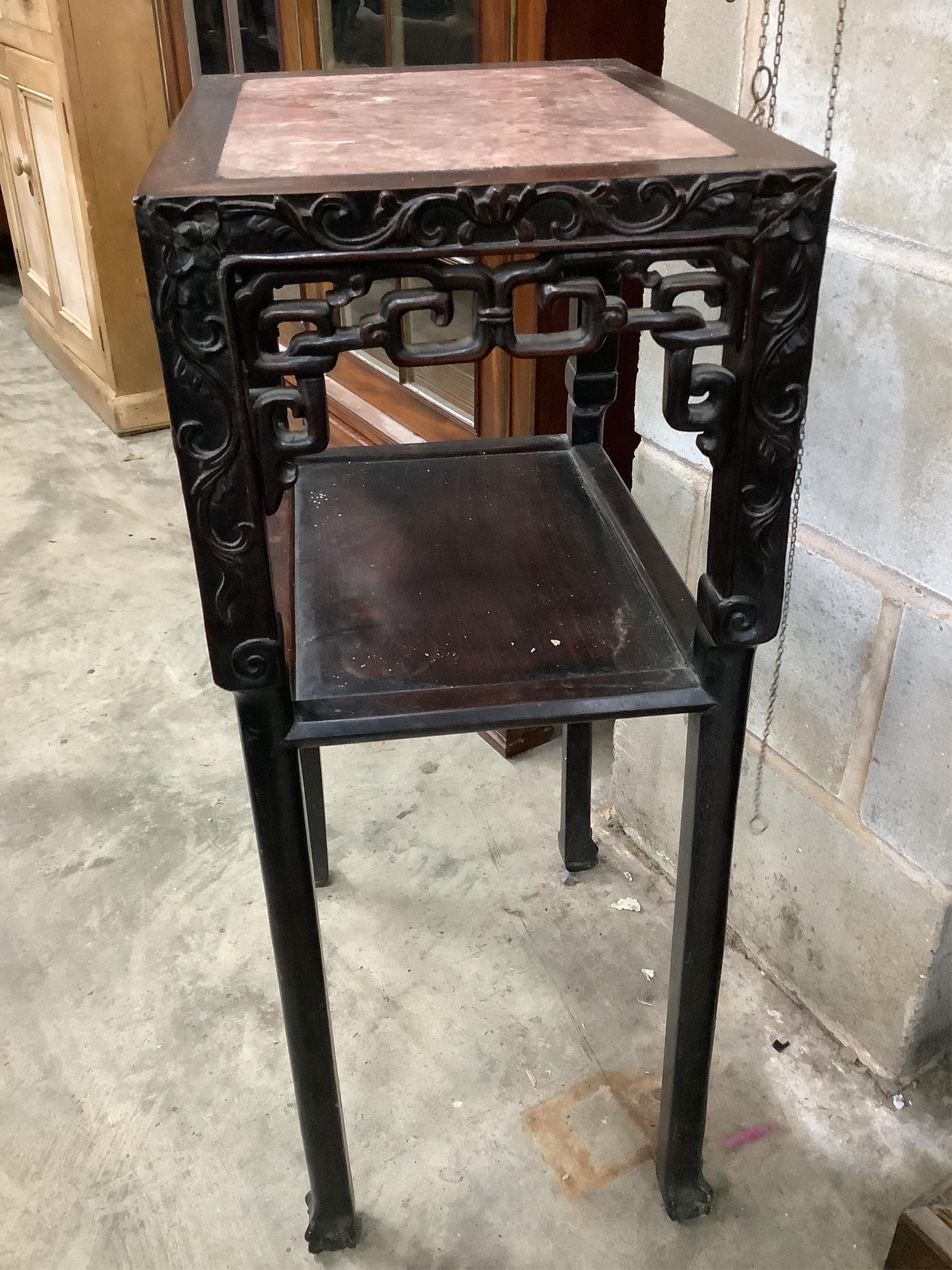 A Chinese carved hardwood urn stand, width 42cm, depth 32cm, height 81cm. Condition - fair